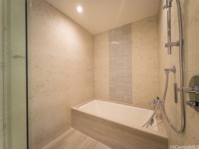 bathroom featuring wood-type flooring and separate shower and tub