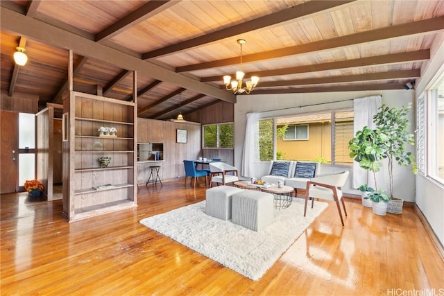 living room with vaulted ceiling with beams, wooden ceiling, a notable chandelier, and wood finished floors