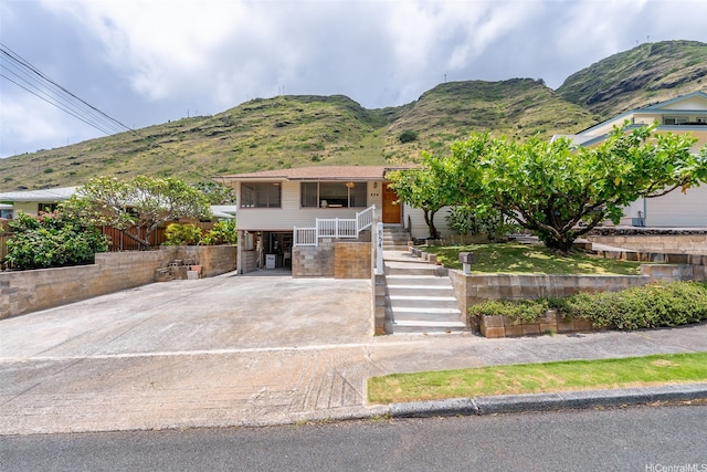 854 Hao St, Honolulu, HI 96821 - view of front of house featuring covered porch, driveway, a carport, a mountain view, and stairs