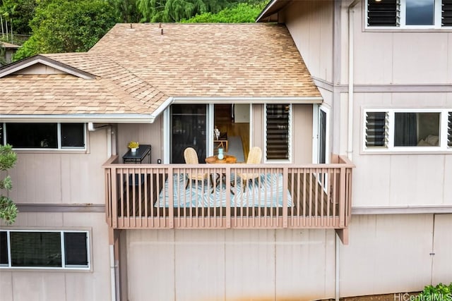 rear view of property featuring a balcony