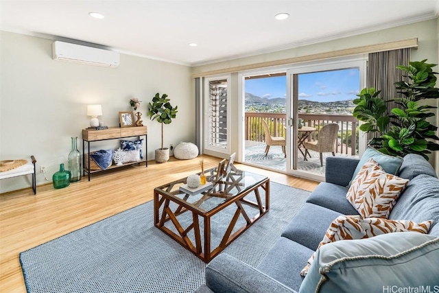 living room featuring an AC wall unit, hardwood / wood-style flooring, and ornamental molding