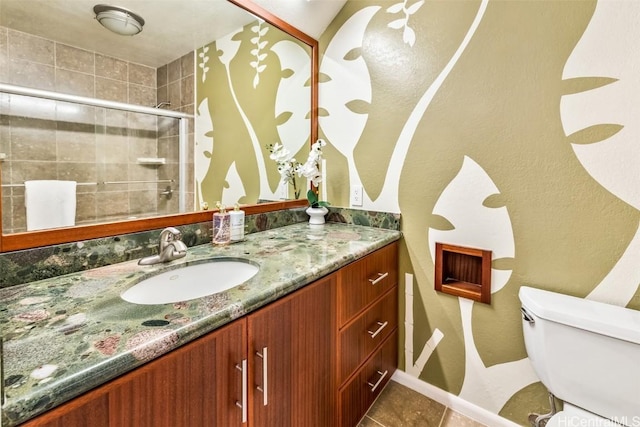 bathroom with vanity, toilet, a shower with door, and tile patterned flooring