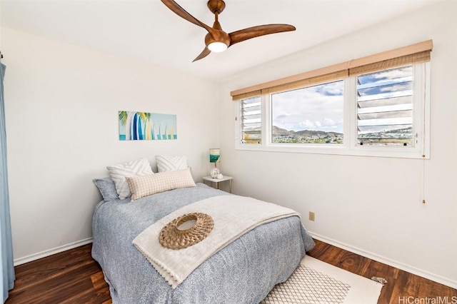 bedroom with ceiling fan and dark hardwood / wood-style flooring