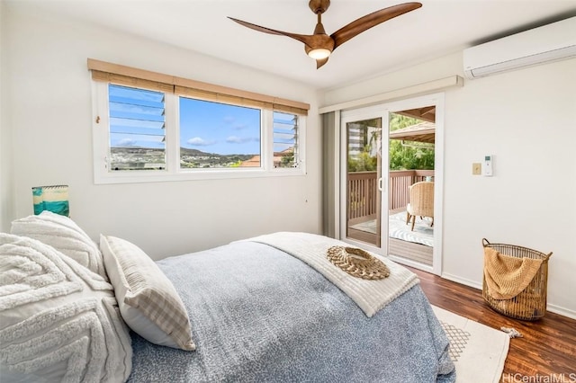 bedroom featuring access to exterior, an AC wall unit, dark wood-type flooring, and ceiling fan