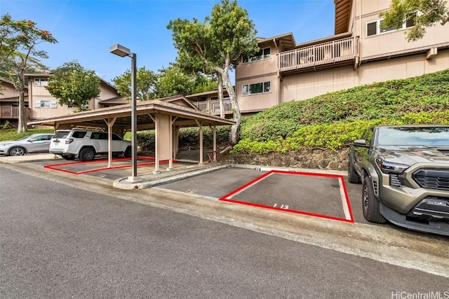 view of vehicle parking with a carport