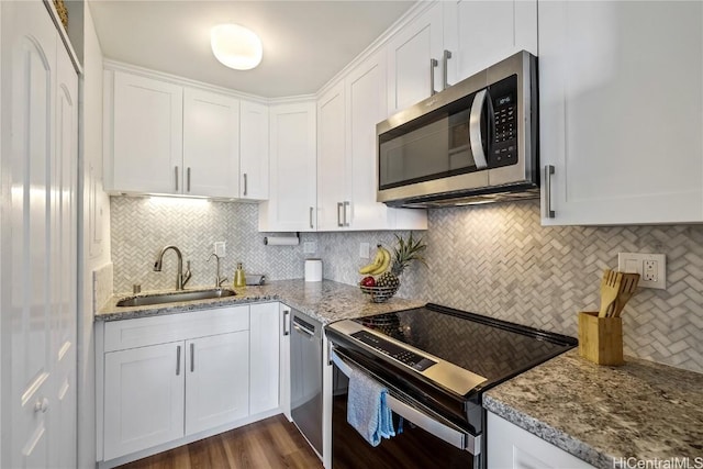 kitchen with white cabinetry, sink, and electric range