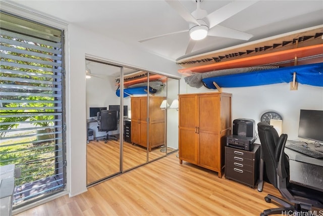 home office featuring ceiling fan and light hardwood / wood-style flooring