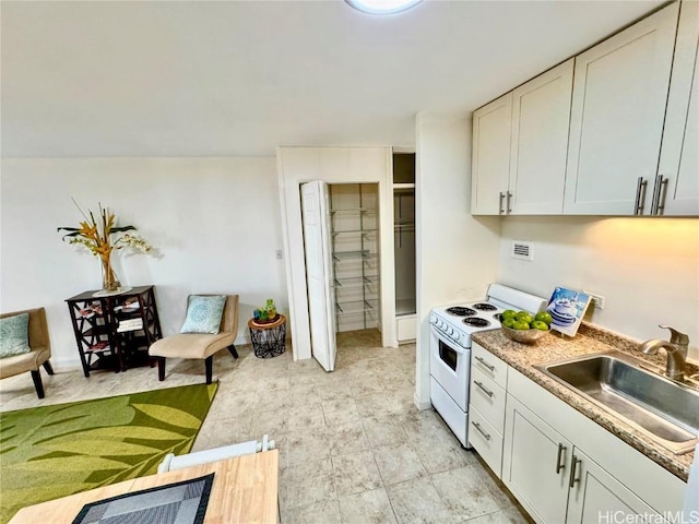 kitchen with white cabinetry, sink, and white range with electric stovetop