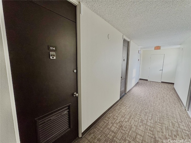 corridor with a textured ceiling