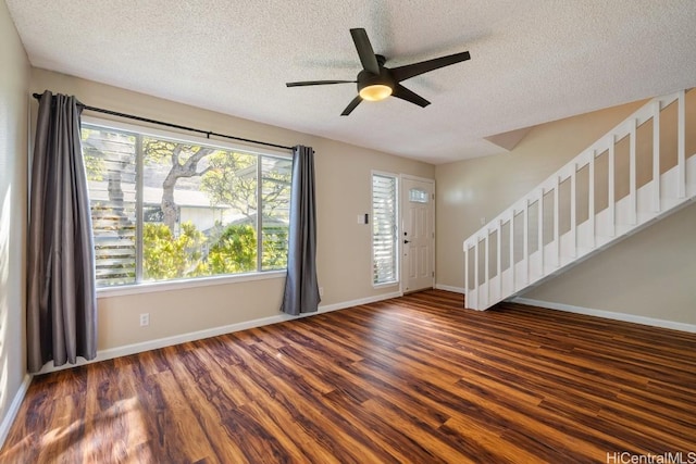 entryway with dark wood-type flooring, a textured ceiling, and plenty of natural light