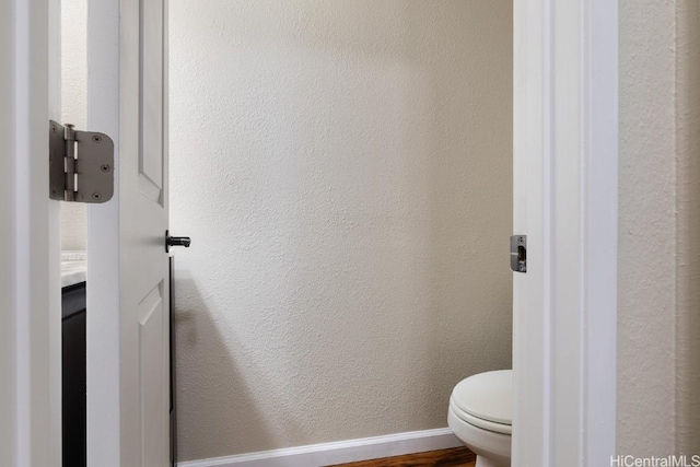 bathroom with vanity, toilet, and wood-type flooring