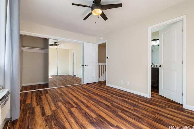 unfurnished bedroom with ceiling fan, dark wood-type flooring, and a closet