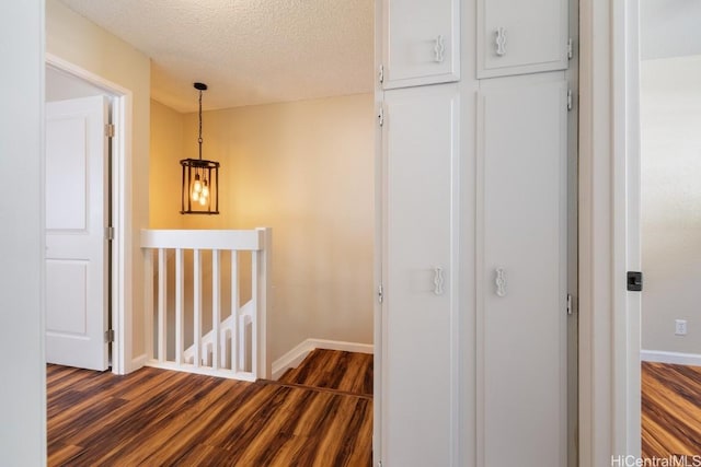 interior space featuring a textured ceiling and dark hardwood / wood-style flooring