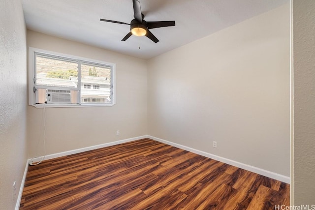 spare room with cooling unit, dark hardwood / wood-style floors, and ceiling fan