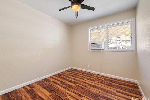 spare room with cooling unit, ceiling fan, and dark hardwood / wood-style floors