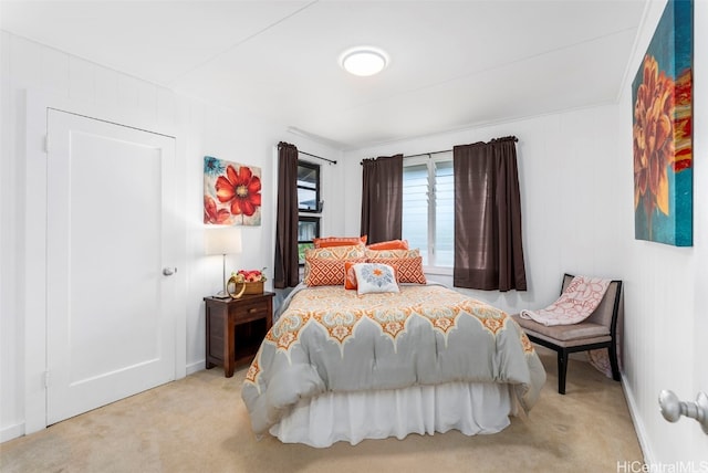 bedroom featuring light carpet