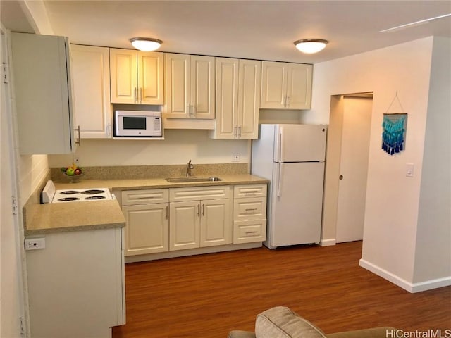 kitchen featuring sink, white appliances, dark hardwood / wood-style floors, and white cabinets