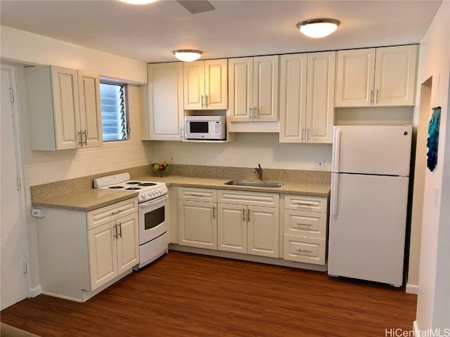 kitchen with dark hardwood / wood-style flooring, sink, white appliances, and white cabinets