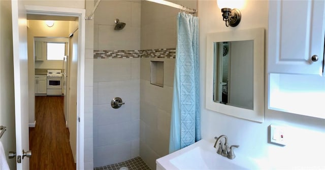 bathroom featuring walk in shower and sink