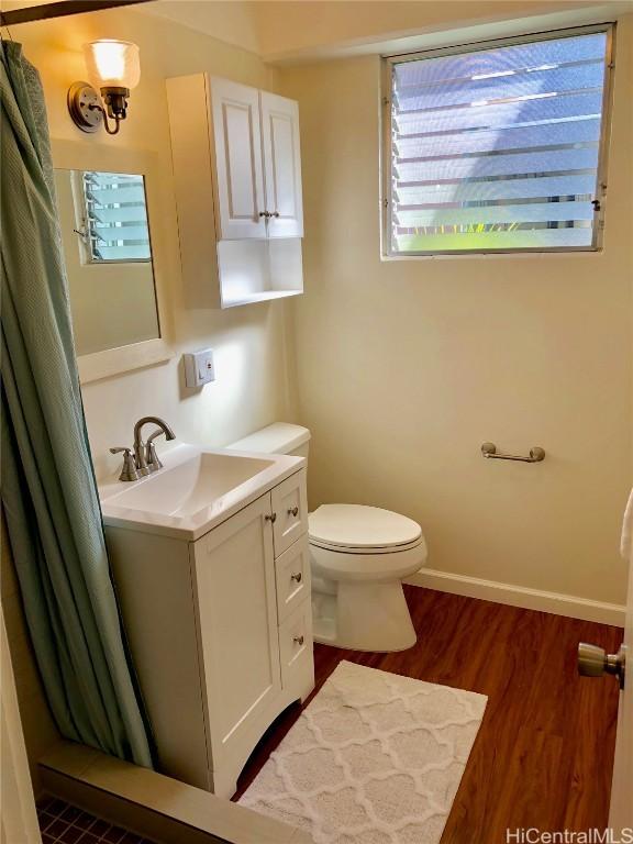 bathroom featuring hardwood / wood-style flooring, vanity, and toilet