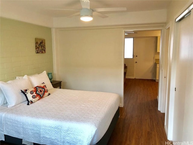 bedroom with ceiling fan and dark hardwood / wood-style flooring