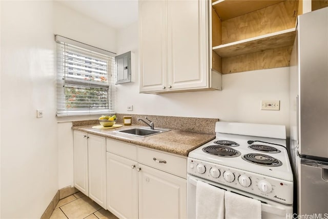 kitchen with sink, white cabinetry, light tile patterned floors, white range with electric stovetop, and stainless steel refrigerator