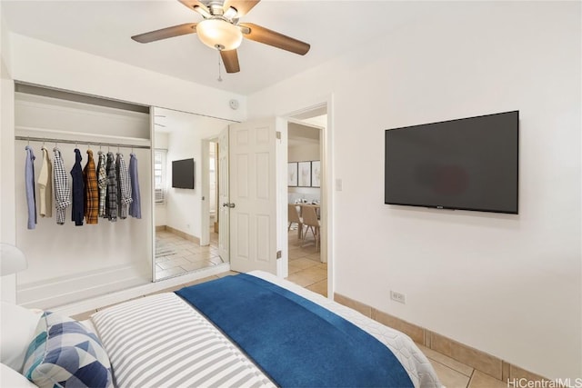 tiled bedroom featuring a closet, ceiling fan, and connected bathroom