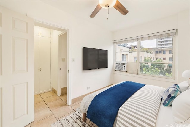 tiled bedroom featuring ceiling fan and cooling unit