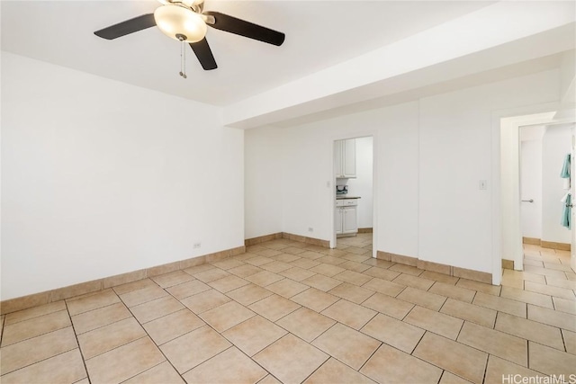 tiled spare room with ceiling fan