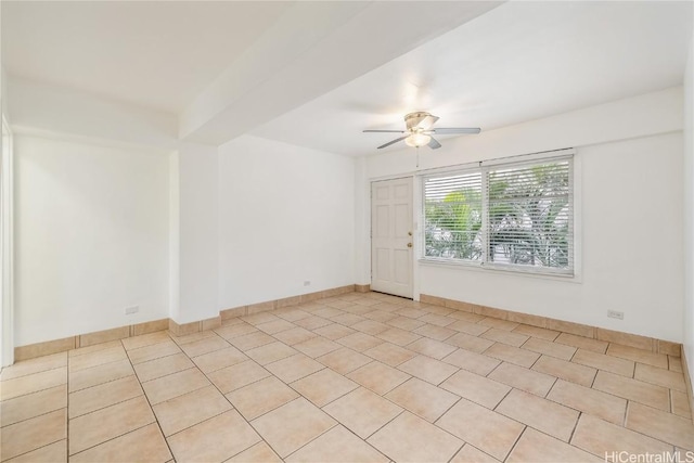 tiled spare room featuring ceiling fan