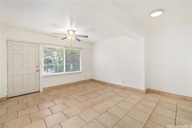 unfurnished room with ceiling fan and light tile patterned flooring