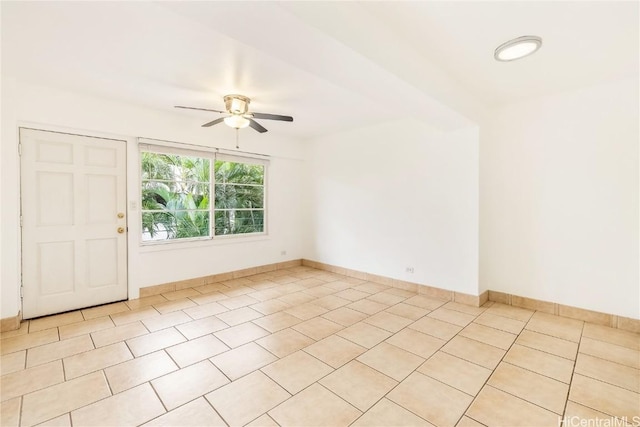 tiled empty room featuring ceiling fan