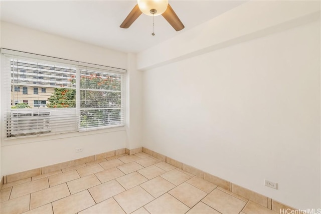 tiled spare room with ceiling fan