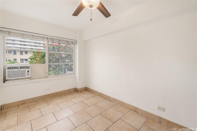 tiled spare room featuring cooling unit and ceiling fan