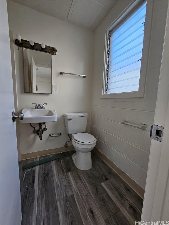 bathroom with sink, hardwood / wood-style floors, and toilet