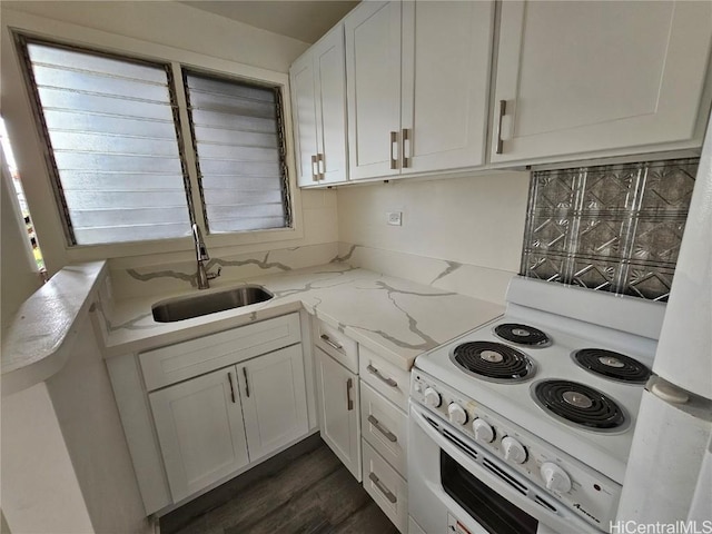 kitchen featuring sink, white appliances, light stone countertops, white cabinets, and kitchen peninsula