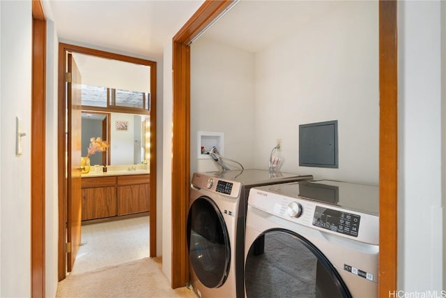 laundry room with light colored carpet, electric panel, washer and clothes dryer, and sink