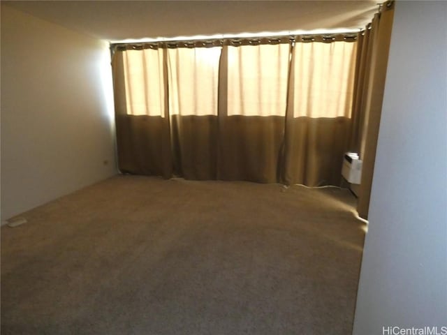 carpeted empty room with a wall mounted air conditioner