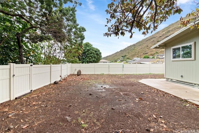 view of yard with a mountain view and a patio