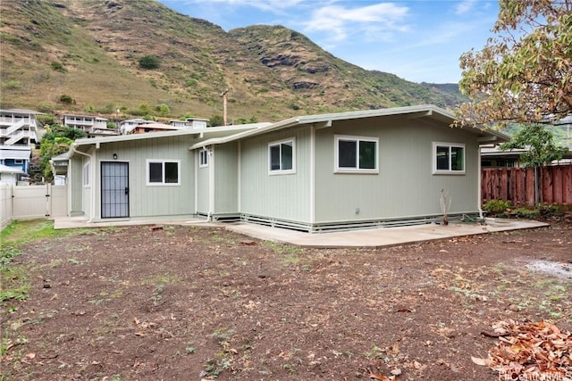 back of property featuring a patio and a mountain view