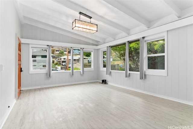 unfurnished sunroom with vaulted ceiling with beams