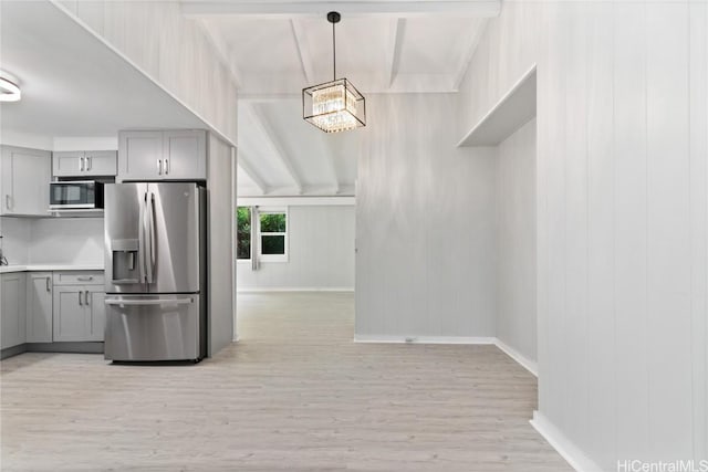 kitchen featuring gray cabinets, appliances with stainless steel finishes, pendant lighting, light hardwood / wood-style floors, and beam ceiling