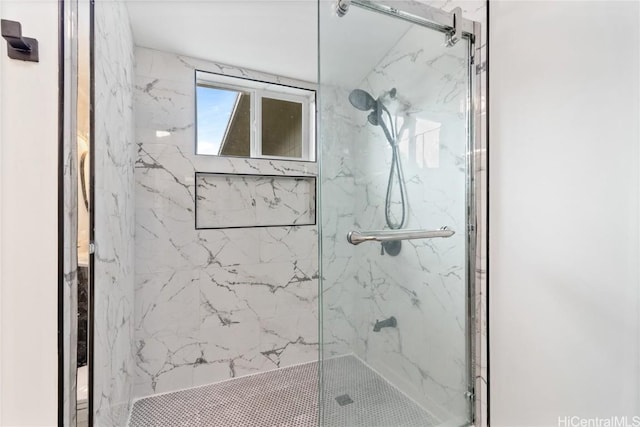 bathroom featuring a shower with shower door