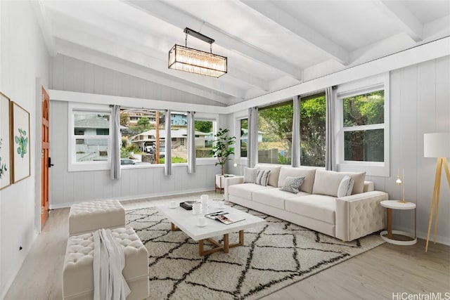 sunroom featuring a wealth of natural light and lofted ceiling with beams