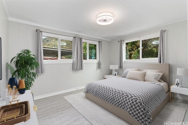 bedroom with hardwood / wood-style flooring and ornamental molding