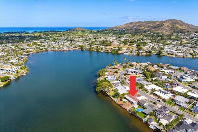 birds eye view of property with a water and mountain view