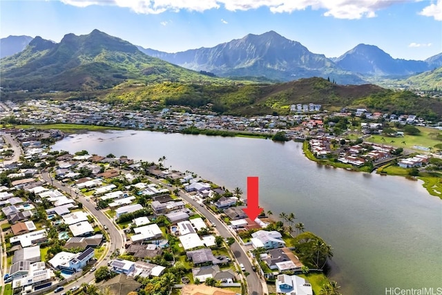 drone / aerial view featuring a water and mountain view