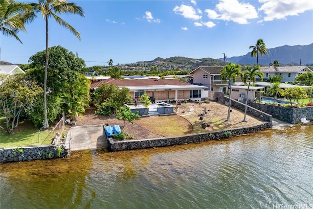 rear view of house with a water and mountain view