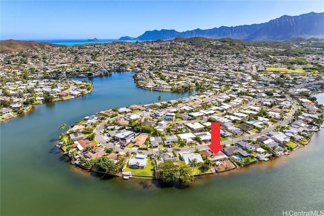 drone / aerial view with a water and mountain view