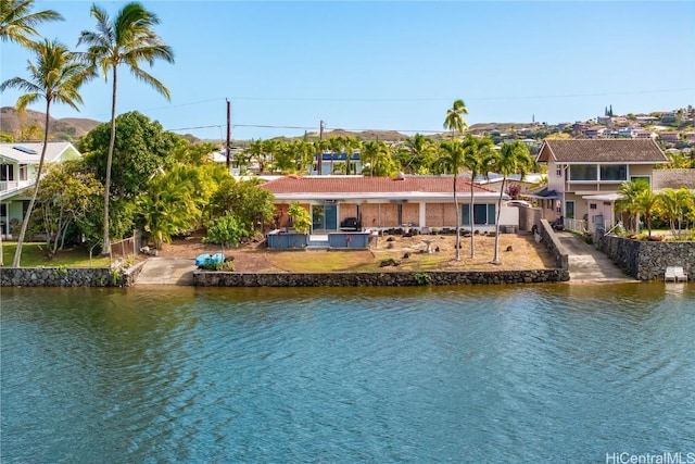 back of house featuring a water view